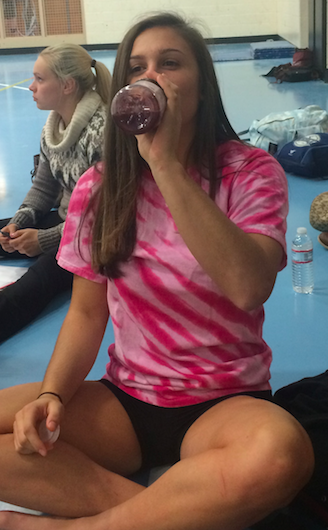 Issy Cerundolo stays hydrated before she hits the mat for practice.  